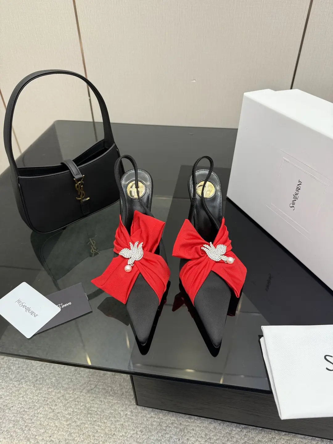 three hundred
Saint Laurent bow sandals with pointed tips
