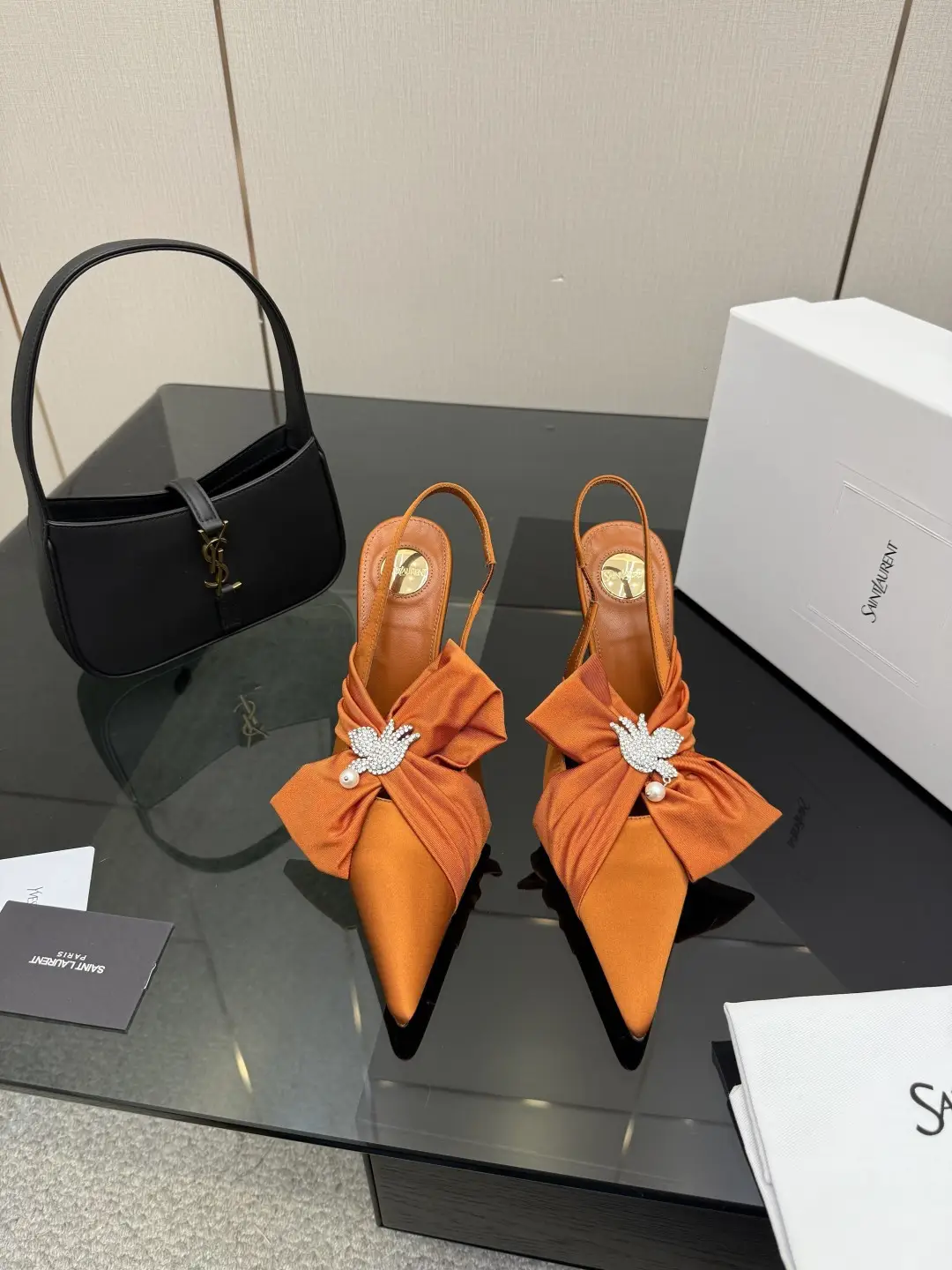three hundred
Saint Laurent bow sandals with pointed tips