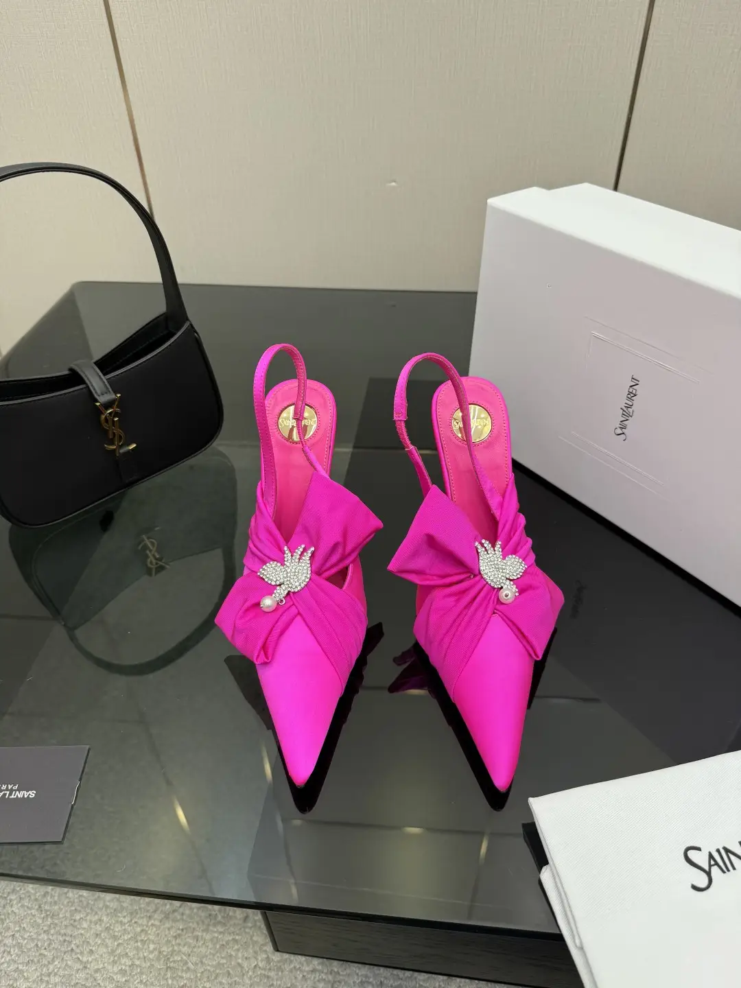 three hundred
Saint Laurent bow sandals with pointed tips