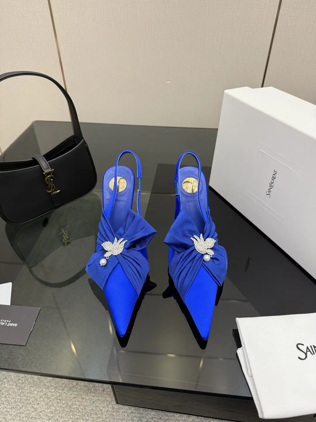 three hundred
Saint Laurent bow sandals with pointed tips