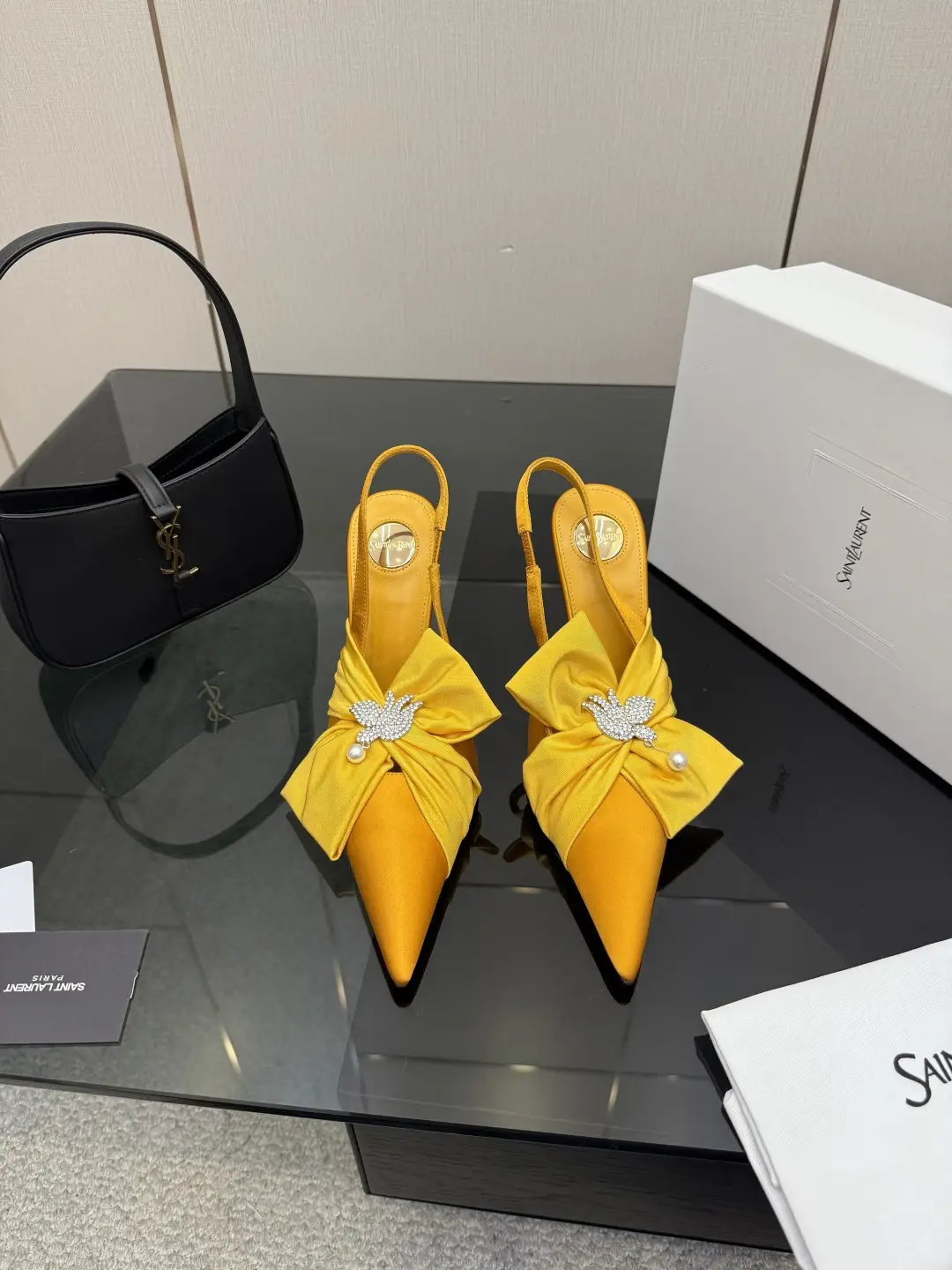three hundred
Saint Laurent bow sandals with pointed tips