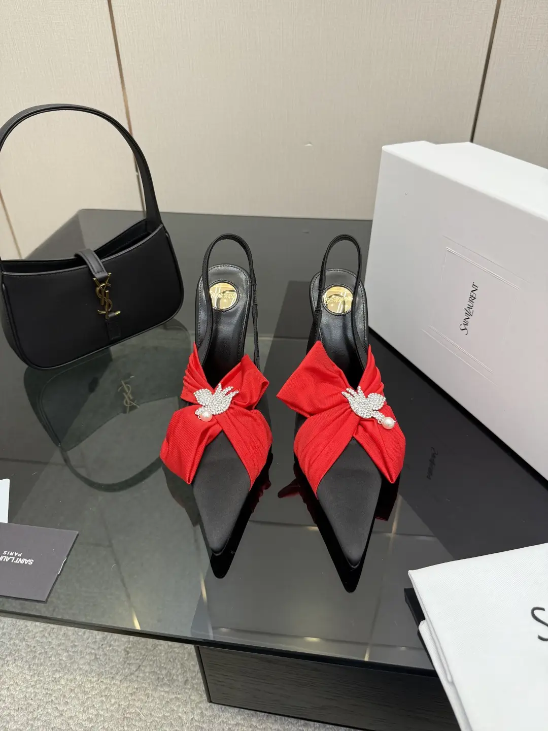 three hundred
Saint Laurent bow sandals with pointed tips