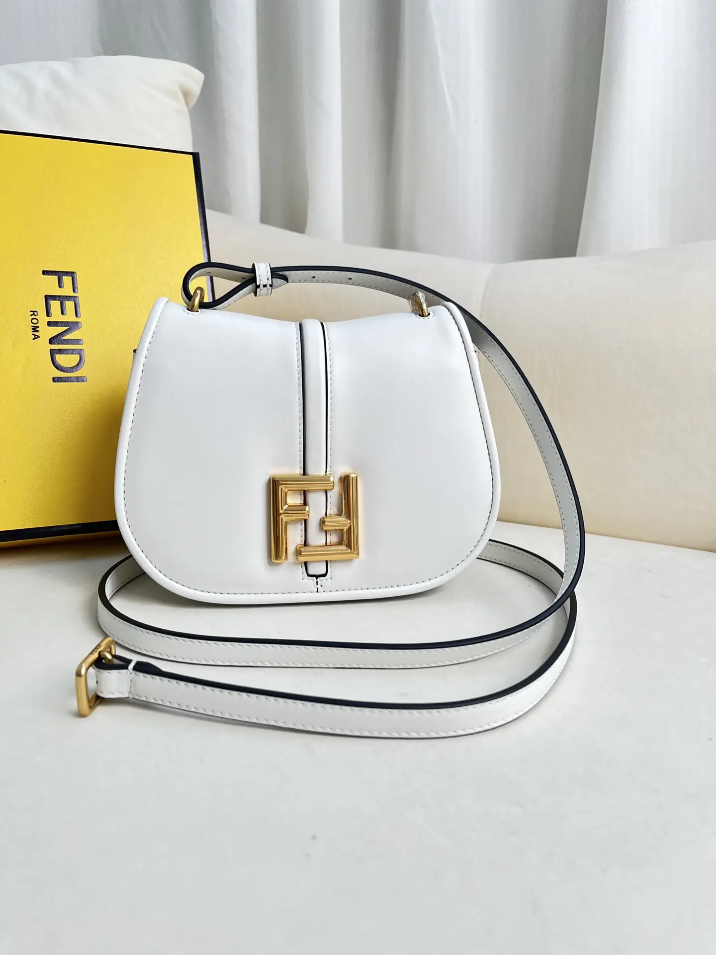 FENDI white leather material small shoulder bag, featuring a feminine curved design